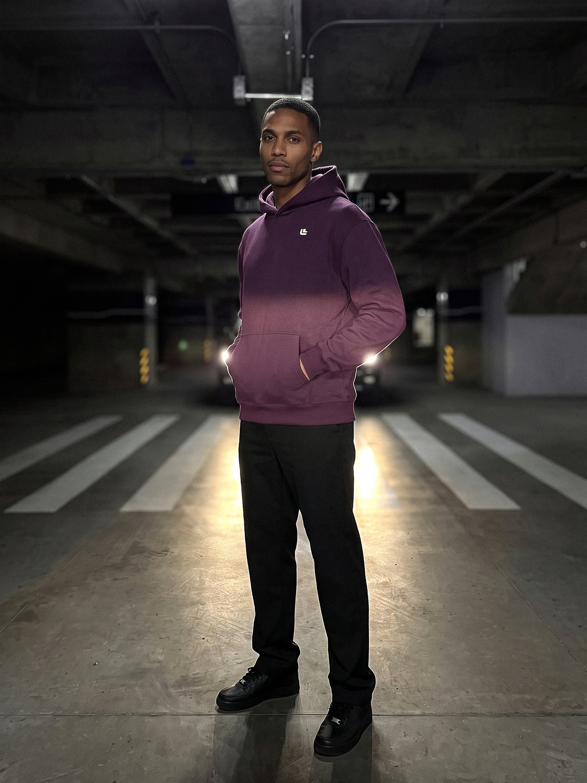 Model trägt den Driving the Limit Hoodie in Plum von vorne mit kleinem Brustlogo